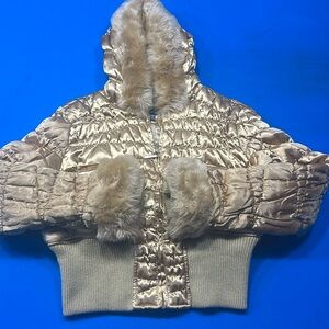 Woman’s gold puffer jacket